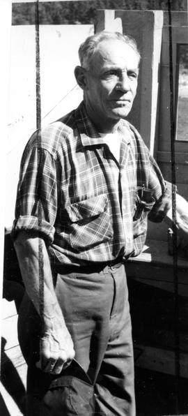 Photograph of an unidentified man wearing a plaid shirt