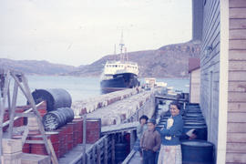 Photograph of Mrs. Sam Lyall and two children standing by a dock in Nain, Newfoundland and Labrador