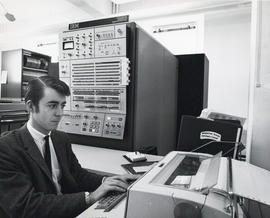 Photograph of an unidentified man working on a computer at the Dalhousie Computer Centre