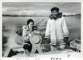Photograph of Barbara Hinds steering a boat with Pitsolak