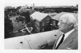 Photograph of Henry Hicks standing on the roof of the Henry Hicks Academic Administration Building