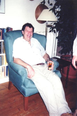 Photograph of Bill Owen seated in armchair at his farewell party