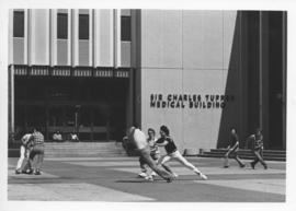 Photograph of a game in front of the Tupper Medical Building