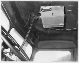 Photograph of a DT65 mobile radio unit mounted in the cab of a snow plow in Prince Edward Island