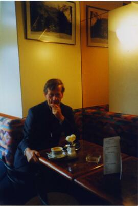 Photograph of a man in a cafe