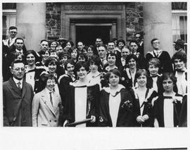 Photograph of graduates standing in front of Shirreff Hall