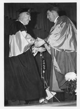 Photograph of Henry Hicks conferring an honorary degree on Dr. Beveridge