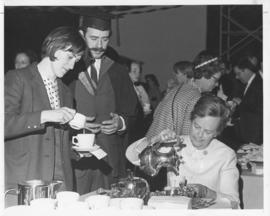 Photograph of an unidentified person serving tea at a convocation tea