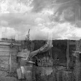 Double exposure photograph of a building and a man with a rifle