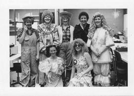 Photograph of circulation desk employees wearing costumes