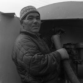 Photograph of a man with a water truck in northern Quebec