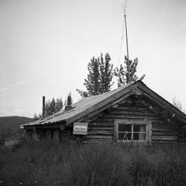 Photograph of a log cabin post office in the Yukon