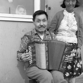 Photograph of Jimmy Koneak with his wife and an accordion in Fort Chimo, Quebec