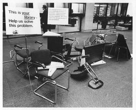 Photograph of broken chairs and other equipment