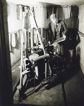 Photograph of man with large piece of equipment in the Science Building