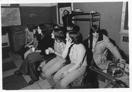 Photograph of high school students watching a slide presentation