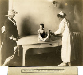 Photograph of Massachusetts-Halifax Health Commission nurse weighing a baby