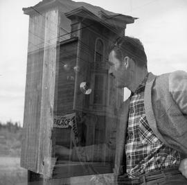 Double exposure photograph of a building and a man with a telephone