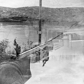 Double exposure photograph of a truck and equipment near the water near Dawson City, Yukon