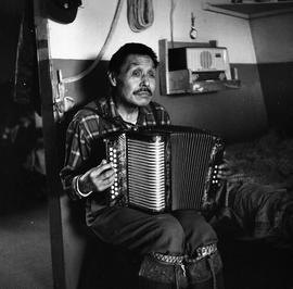 Photograph of Jimmy Koneak playing the accordion in Fort Chimo, Quebec
