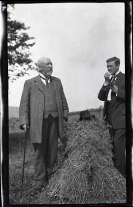 Two men in a hay field
