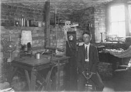 Photograph of Prof. H.A. Bumstead in his room making vacuum to split atoms and A.S. MacKenzie mea...