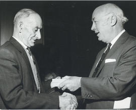 Photograph of Dr. Henry D. Hicks presenting a gift to A. Sampson