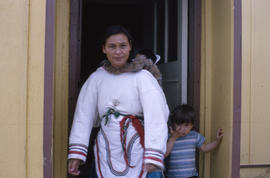 Photograph of Joanna Koneak standing in a doorway with two children