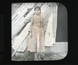 Photograph of unidentified Mi'kmaq girl standing in front of wigwam