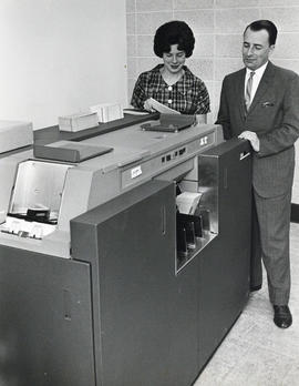 Photograph of Judy Hunter and an unidentified man with the Dalhousie computer in the Sir James Du...