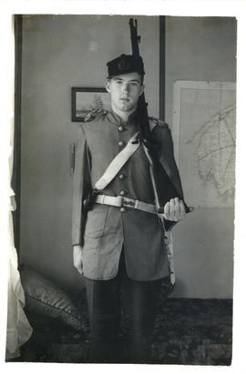 Portrait of Arthur White holding a rifle and dressed as a Nova Scotia militiaman of 1865