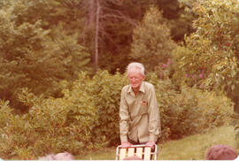 Photograph of Hope V. McPhee leaning on a chair at the First Roscoe Fillmore Memorial Picnic