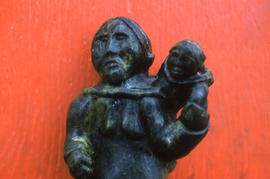 Photograph of a stone sculpture of a woman and child from Cape Dorset, Northwest Territories