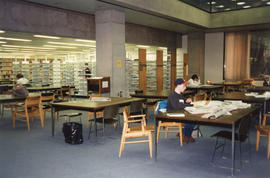 Photograph of students working tables  in a stack reading area in the Killam Memorial Library, Da...