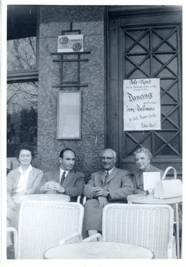 Photograph of Maureen Beren, the courier Angelo, Thomas Head and Edith Raddall sitting on an outd...