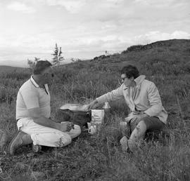 Photograph of a man and a woman having a picnic in Dawson City, Yukon