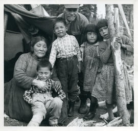 Photograph of a Naskapi family outside of their tent in Davis Inlet, Newfoundland and Labrador