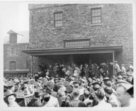 Photograph of looters carting cases of beer outside of Keith's Brewery on Lower Water Street duri...