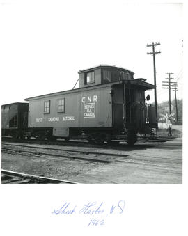 Photograph of the caboose of a CNR train sitting at a rail crossing in Sheet Harbour, Nova Scotia