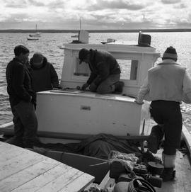 Photograph of four men on the Joan Ryan in Fort Chimo, Quebec