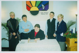 Photograph of Reverend Darlene Young signing marriage certificate