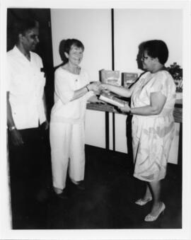 Photograph of Elisabeth Mann Borgese presenting copies of the "Ocean Yearbook"