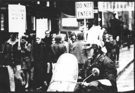 Photograph of marchers on Hollis Street during an anti-Vietnam War demonstration, overseen by a m...