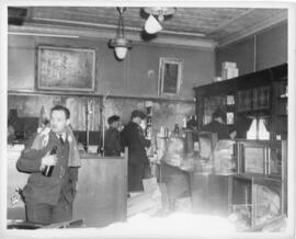 Photograph of RCAF men drinking beer and browsing though a ransacked shop during the Halifax VE-D...