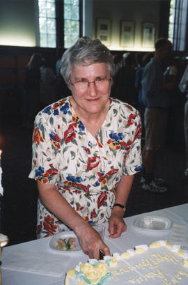 Photograph of Patricia Lutley cutting a cake at her retirement party