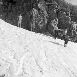 Photograph of three people playing in the snow in the Yukon