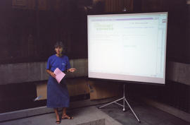 Photograph of librarian Gwyn Pace demonstrating how to use Novanet Express at the Killam Web Café