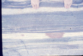 Photograph of feet on a sedimentary rock in Hopedale, Newfoundland and Labrador