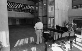 Photograph of an unidentified person playing the piano in the Dalhousie Arts Centre