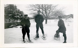 Photograph of Thomas Head Raddall with Alfred McCoy and Roy Gordon wearing snowshoes and carrying...